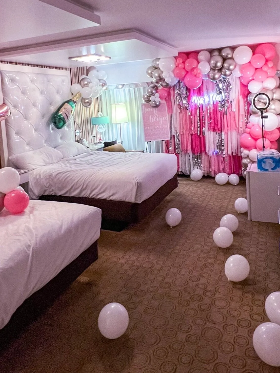 Vip Package suite decorated by Las Vegas Bach — pink balloon garlands and fringe backdrop